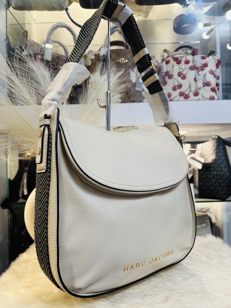 Marc Jacobs The Groove Large Shoulder Bag (Category: Luxury Bags & Wallets) located in Porac. Submitted by bagitupshopph (Listing ID 1424614557, Image 3). Description: 💯 Authentic from USA Marc Jacobs The Groove Large Shoulder Bag in Marshmallow Color and Gold Hardware Comes with tag and carecard Cream-colored shoulder bag from Marc Jacobs. Features a flap closure and a zipper. The bag has a black and white patterned strap. The interior is cream