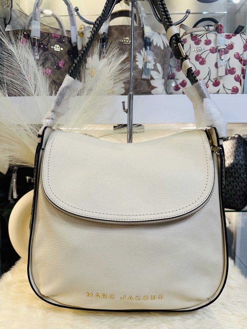 Marc Jacobs The Groove Large Shoulder Bag (Category: Luxury Bags & Wallets) located in Porac. Submitted by bagitupshopph (Listing ID 1424614557, Image 2). Description: 💯 Authentic from USA Marc Jacobs The Groove Large Shoulder Bag in Marshmallow Color and Gold Hardware Comes with tag and carecard Cream-colored shoulder bag from Marc Jacobs. Features a flap closure and a zipper. The bag has a black and white patterned strap. The interior is cream