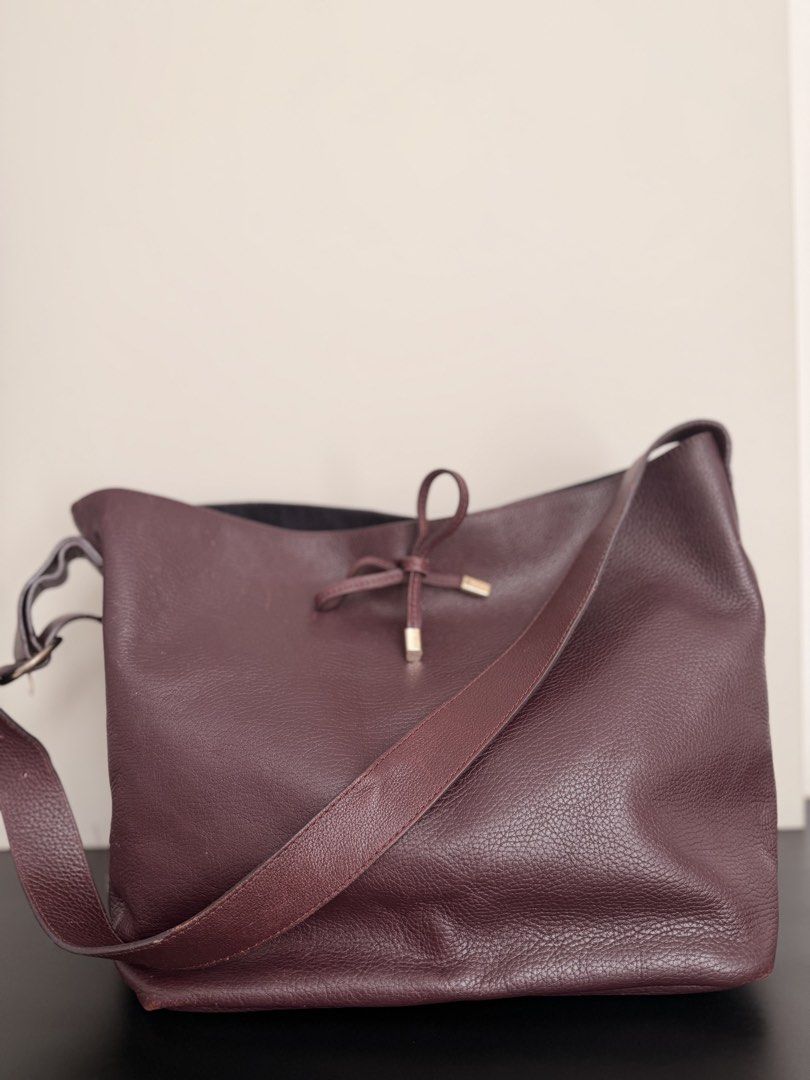 Massimo Dutti Medium Bag (Category: Luxury Bags & Wallets) located in Quezon City. Submitted by omgalicia (Listing ID 1424564373, Image 2). Description: - Massimo Dutti medium bag - Made in Spain - Drawstring closure - Shoulder strap with gold-tone buckle - Deep burgundy color - Textured leather exterior - Interior zipper closure - Minor marks on exterior.