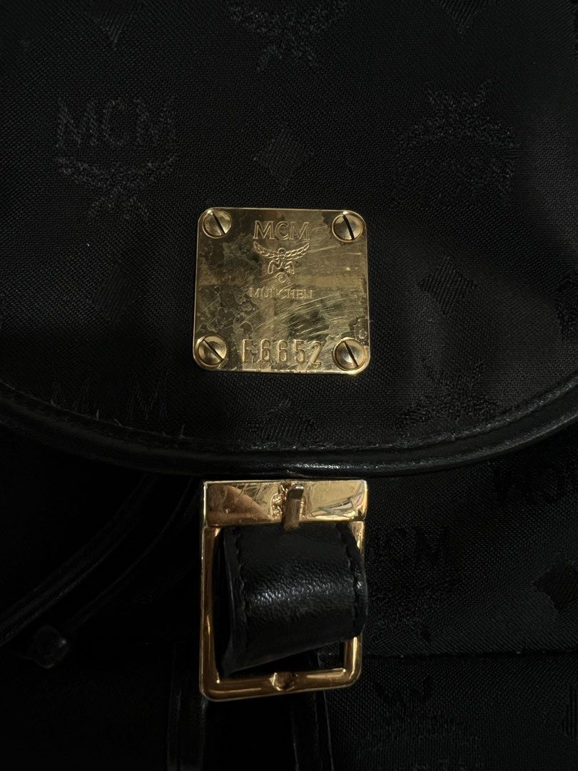 MCM Germany Black Backpack (Category: Luxury Bags & Wallets) located in Batangas. Submitted by aizenaudrix232429 (Listing ID 1424547849, Image 3). Description: - Authentic MCM backpack - Black with signature logo pattern - Flap closure with buckle - Two front pockets - Top handle - Side zipper - Adjustable straps - Gold-tone logo emblem.