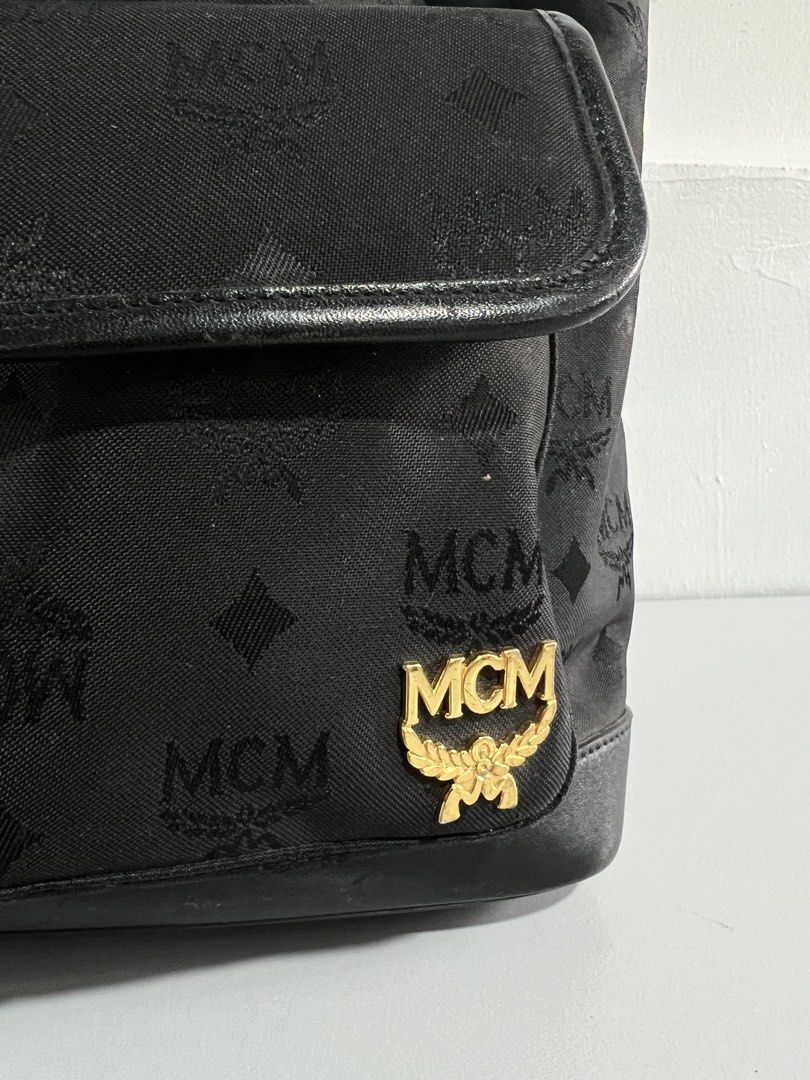 MCM Germany Black Backpack (Category: Luxury Bags & Wallets) located in Batangas. Submitted by aizenaudrix232429 (Listing ID 1424547849, Image 2). Description: - Authentic MCM backpack - Black with signature logo pattern - Flap closure with buckle - Two front pockets - Top handle - Side zipper - Adjustable straps - Gold-tone logo emblem.