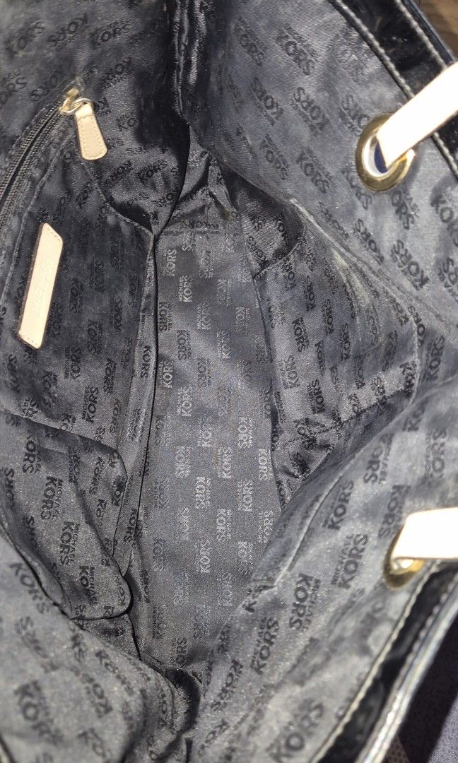 Michael Kors Black Tote Bag (Category: Tote Bags) located in Del Monte. Submitted by aabbuico (Listing ID 1424170104, Image 3). Description: - Michael Kors black tote bag - Glossy finish with MK logo pattern - Beige leather straps - Gold-tone hardware - Includes MK logo charm - Spacious design - Ideal for everyday use.