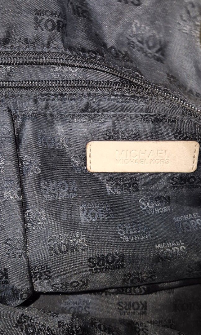 Michael Kors Black Tote Bag (Category: Tote Bags) located in Del Monte. Submitted by aabbuico (Listing ID 1424170104, Image 2). Description: - Michael Kors black tote bag - Glossy finish with MK logo pattern - Beige leather straps - Gold-tone hardware - Includes MK logo charm - Spacious design - Ideal for everyday use.
