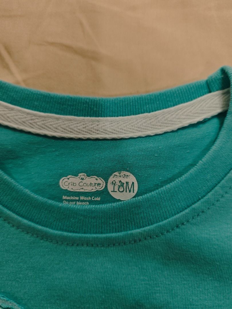Crib Couture Toddler T-Shirt (Category: Babies & Kids Fashion) located in Quezon City. Submitted by declutteringmami (Listing ID 1424697111, Image 2). Description: Turquoise t-shirt features a fun monster face design. It has a round neckline and short sleeves. The shirt has a size tag visible. Perfect for your little one!.