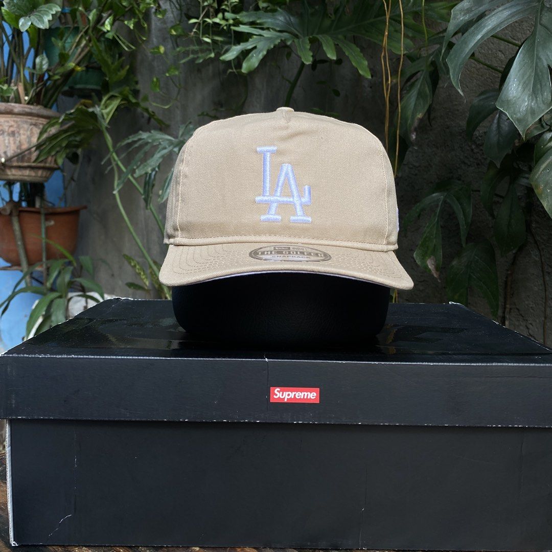 New Era LA Dodgers The Golfer Snapback Cap (Category: Caps & Hats) located in Manila. Submitted by jpdavidso (Listing ID 1424546430, Image 1). Description: - New Era LA Dodgers snapback cap - 'The Golfer' style - Tan color - White embroidery - White underbrim - Black interior - One size fits most.