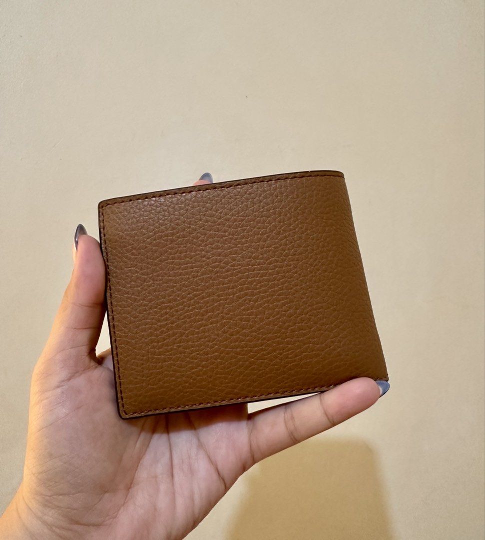 Original MK Cooper Leather Wallet (Category: Wallets & Card Holders) located in Rizal. Submitted by TineStore (Listing ID 1424613435, Image 2). Description: - Genuine Michael Kors Cooper wallet - Brown leather - New with original packaging - Multiple card slots - Bill compartment - Textured exterior - Michael Kors logo visible - Compact design - Ideal for everyday use.