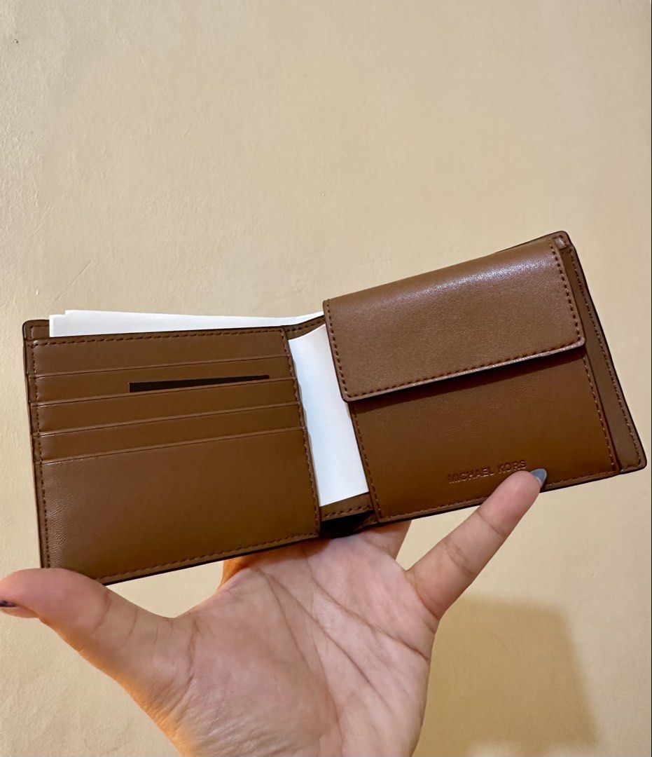 Original MK Cooper Leather Wallet (Category: Wallets & Card Holders) located in Rizal. Submitted by TineStore (Listing ID 1424613435, Image 3). Description: - Genuine Michael Kors Cooper wallet - Brown leather - New with original packaging - Multiple card slots - Bill compartment - Textured exterior - Michael Kors logo visible - Compact design - Ideal for everyday use.