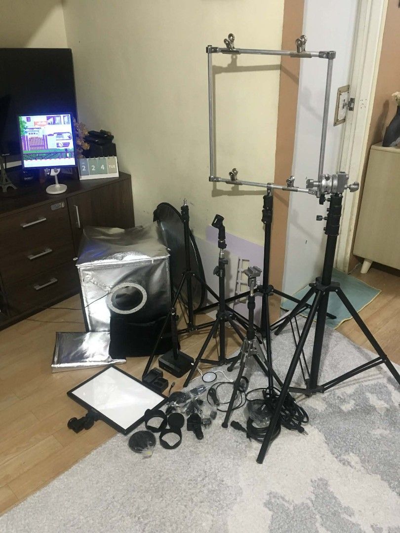 Photography Lighting Kit with Softbox and Tripods (Category: Lighting & Studio Equipment) located in Manila. Submitted by cleverearth.84fa06 (Listing ID 1424526171, Image 2). Description: Photography lighting kit. Includes a softbox with a ring light, multiple tripods, a reflector, and various accessories. Also includes a frame for overhead shots. Perfect for product photography or video recording. All items are included as shown in the images..