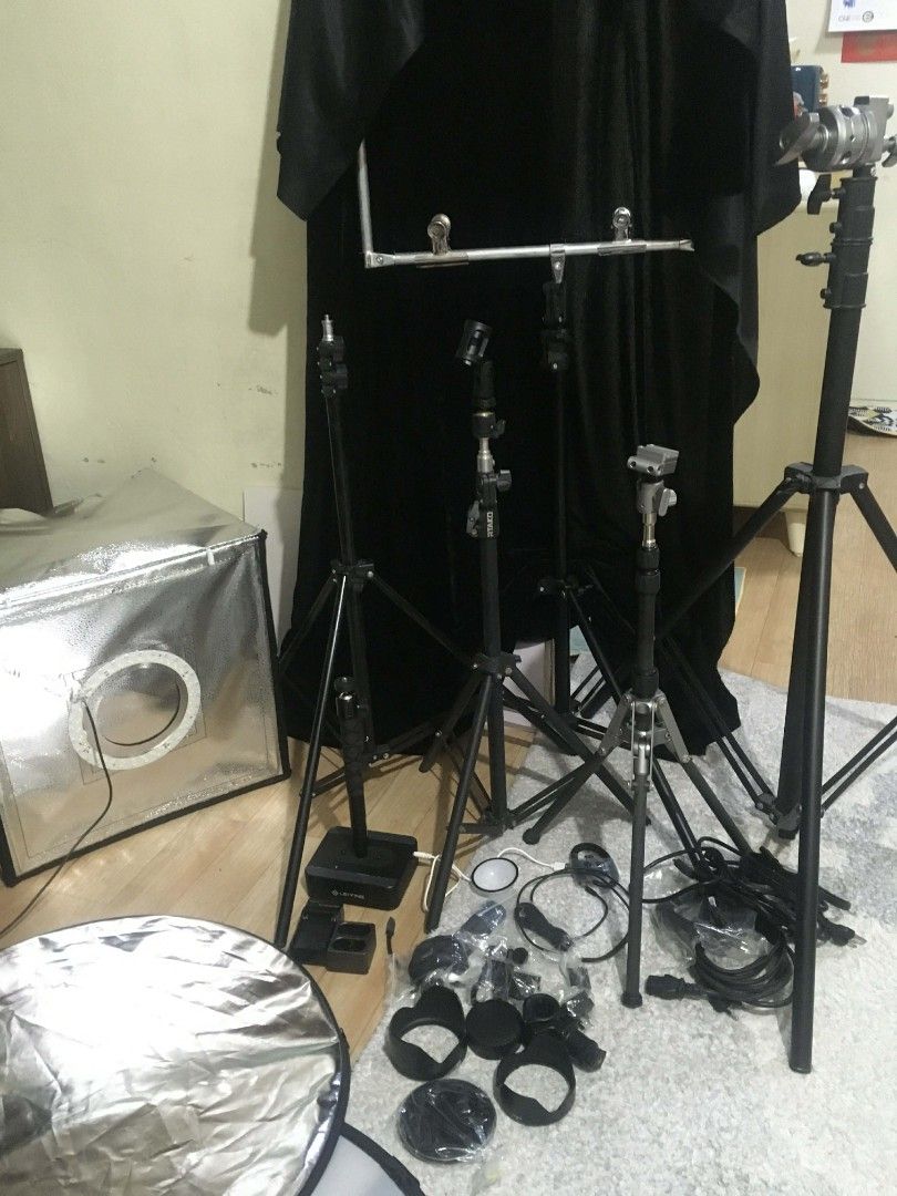 Photography Lighting Kit with Softbox and Tripods (Category: Lighting & Studio Equipment) located in Manila. Submitted by cleverearth.84fa06 (Listing ID 1424526171, Image 1). Description: Photography lighting kit. Includes a softbox with a ring light, multiple tripods, a reflector, and various accessories. Also includes a frame for overhead shots. Perfect for product photography or video recording. All items are included as shown in the images..