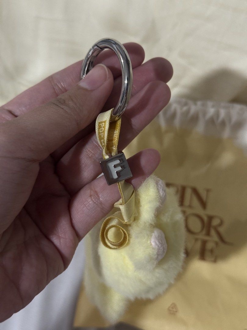 Pop Mart Labubu Pin For Love (Category: Character Goods) located in Valenzuela. Submitted by danabananani (Listing ID 1424627850, Image 3). Description: - Pop Mart Pin For Love Keychain - Features a fluffy yellow character - Smiling face design - Includes a matching drawstring bag - Silver ring keychain - Ribbon with the letter "F" - Character has "F" embroidery on the back - Includes a tag - RFS: Not prio color/letter.