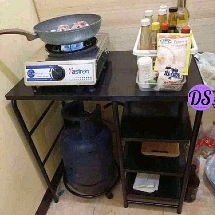 Portable Kitchen Cart with Gas Stove (Category: Other Kitchenware & Tableware) located in Makati City. Submitted by oideme (Listing ID 1424641766, Image 3). Description: - Portable kitchen cart - Built-in gas stove - Shelves for storage - Space for gas tank - Black metal construction - Ideal for small spaces and outdoor use - Simple and functional design.