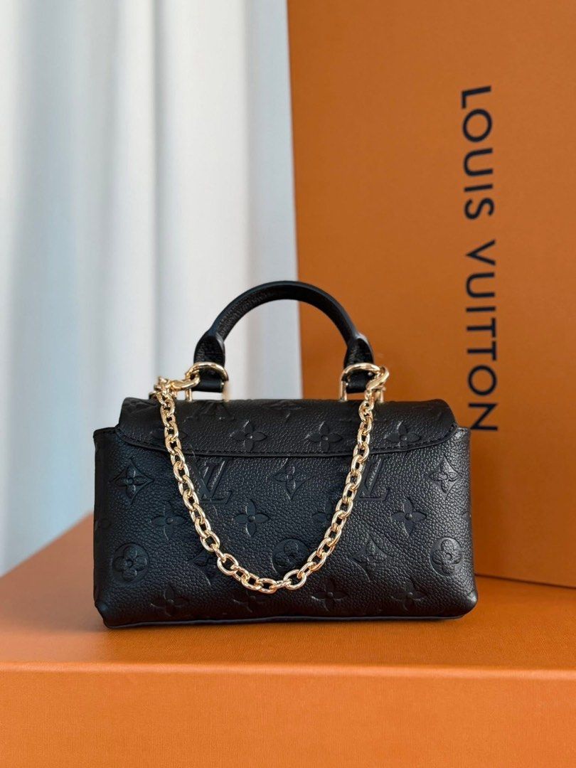 Preloved Mini Dauphine Handbag (Category: Luxury Bags & Wallets) located in Manila. Submitted by bagsandshoesmanymore (Listing ID 1424532256, Image 2). Description: -Preloved Mini Dauphine -Size 19cm - Crafted from black embossed leather - Top handle and detachable chain strap - Gold-tone clasp closure - Interior: Main compartment and slip pocket - Marked "Louis Vuitton Paris made in France".