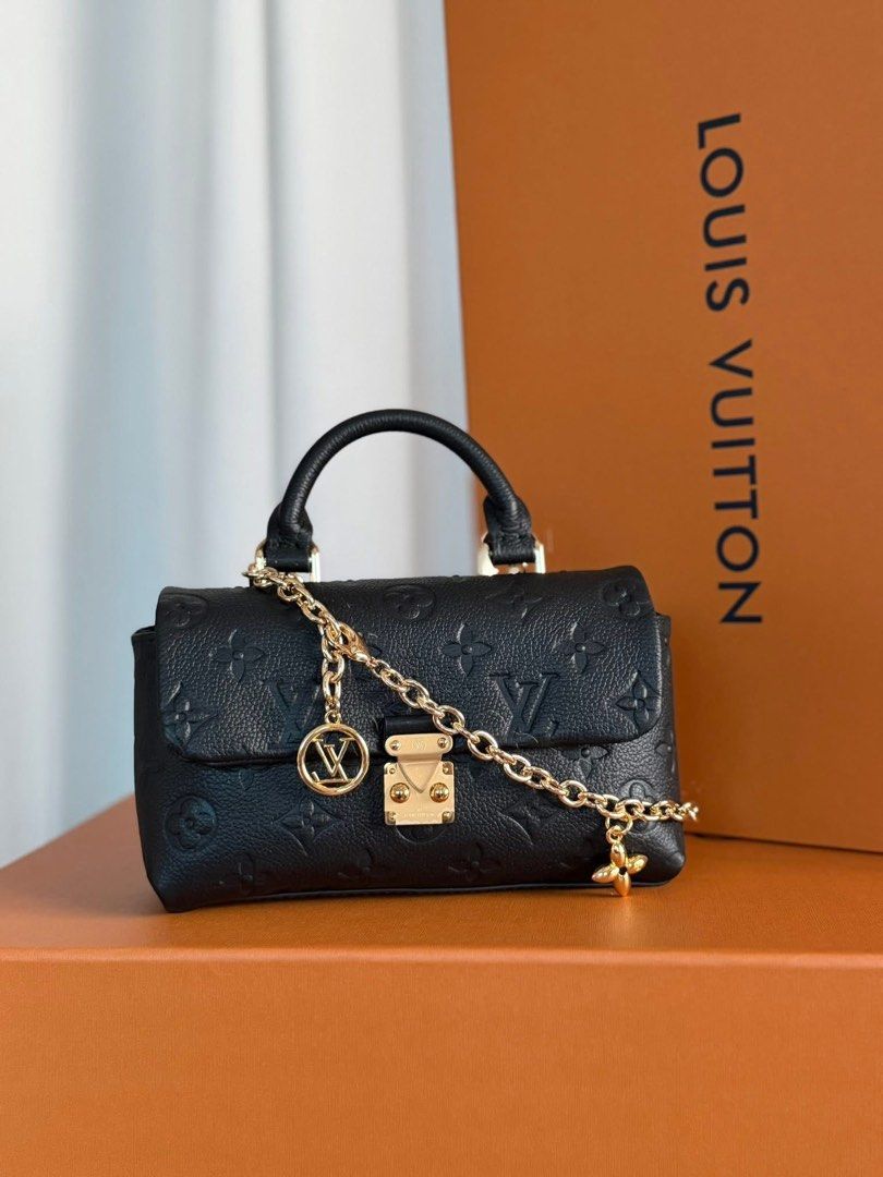 Preloved Mini Dauphine Handbag (Category: Luxury Bags & Wallets) located in Manila. Submitted by bagsandshoesmanymore (Listing ID 1424532256, Image 1). Description: -Preloved Mini Dauphine -Size 19cm - Crafted from black embossed leather - Top handle and detachable chain strap - Gold-tone clasp closure - Interior: Main compartment and slip pocket - Marked "Louis Vuitton Paris made in France".