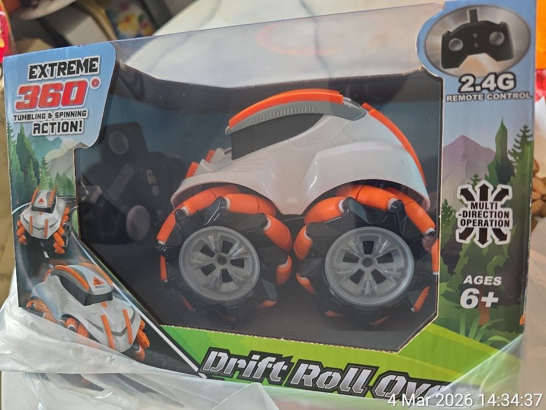 Remote control car (Category: Remote Control Toys) located in Singapore. Submitted by whyisskyblue (Listing ID 1424597607, Image 1). Description: Drift Roll Over Car, a radio-controlled stunt vehicle. Key features and specifications include: Action: Performs 360-degree tumbling, spinning, and drifting stunts. Control: Operates via a 2.4G full-function remote control. Mobility: Engineered for forward, reverse, and turning motions. Power: Typically