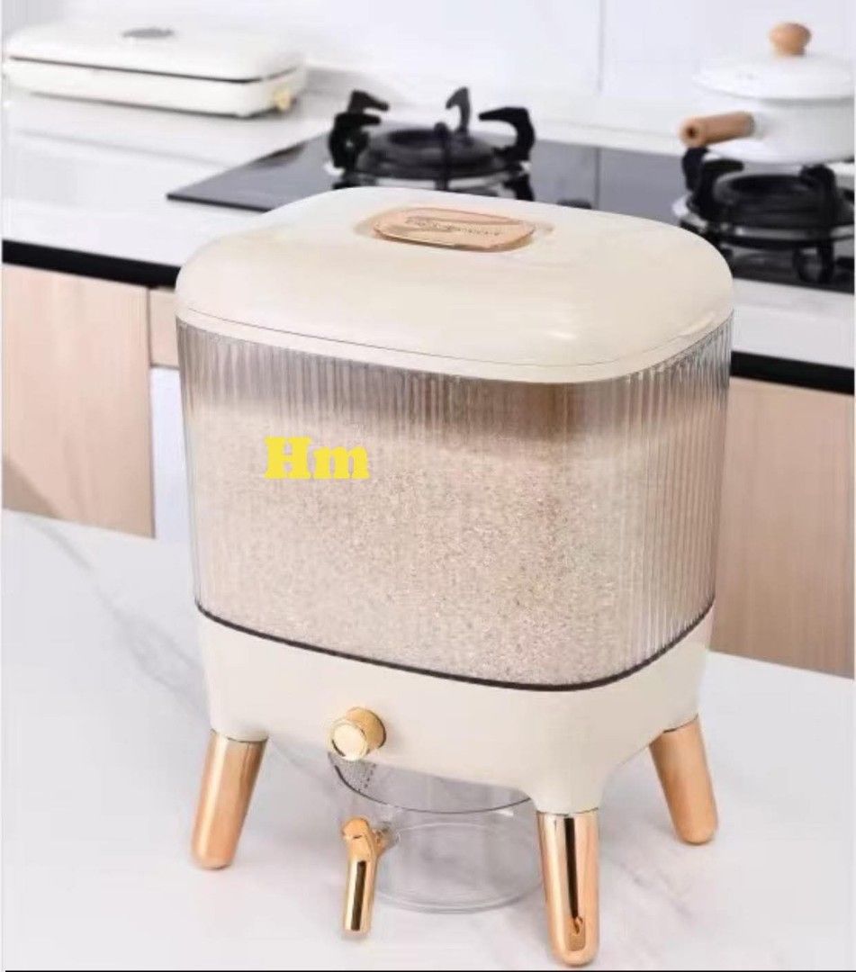 Rice Dispenser with Measuring Cup (Category: Food Organization & Storage) located in Manila. Submitted by jelai.cybyb (Listing ID 1424611406, Image 1). Description: Stylish rice dispenser with a clear container and a convenient measuring cup. Features a modern design with gold-colored accents on the legs. It has a capacity to store a good amount of rice, keeping it fresh and easily accessible. The dispenser has a tap for easy dispensing. Dimensio
