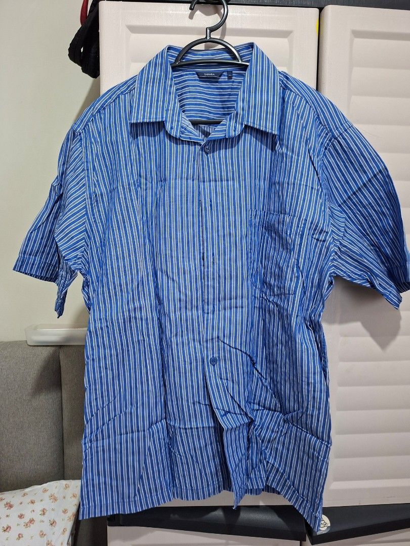 Sahara Striped Shirt - Size L (Category: Tshirts & Polo Shirts ) located in Manila. Submitted by shelly2004 (Listing ID 1424608292, Image 1). Description: - Sahara striped shirt - Size: L - Color: Blue and white - Features: Short sleeves, button-down front, classic collar, chest pocket - Fabric: Lightweight, ideal for warm weather.