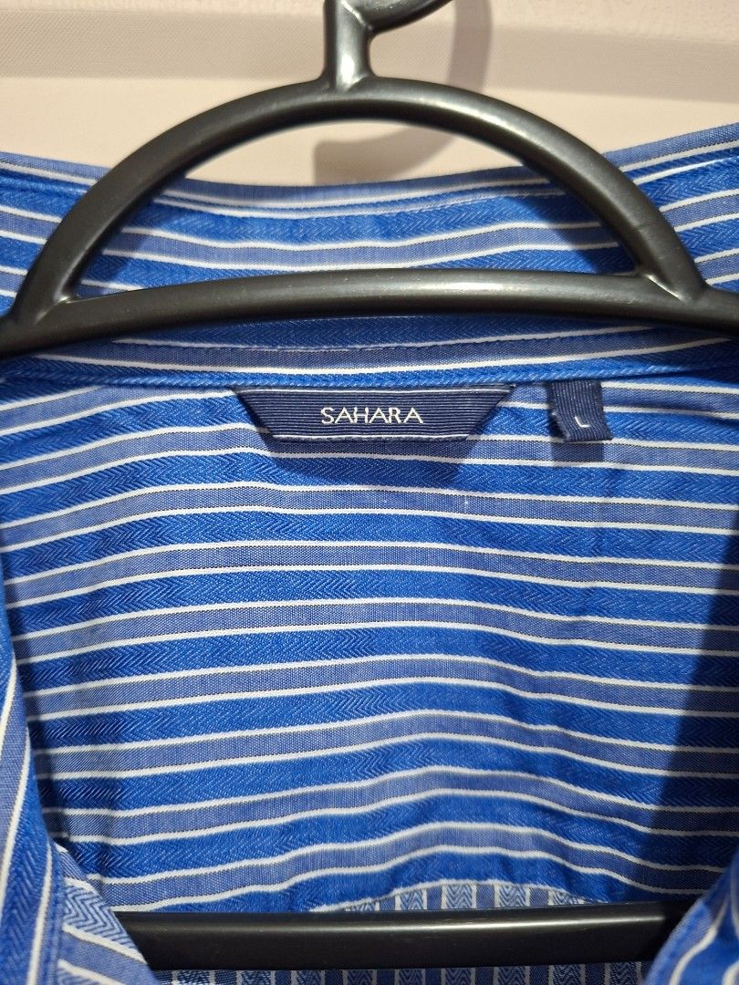 Sahara Striped Shirt - Size L (Category: Tshirts & Polo Shirts ) located in Manila. Submitted by shelly2004 (Listing ID 1424608292, Image 2). Description: - Sahara striped shirt - Size: L - Color: Blue and white - Features: Short sleeves, button-down front, classic collar, chest pocket - Fabric: Lightweight, ideal for warm weather.