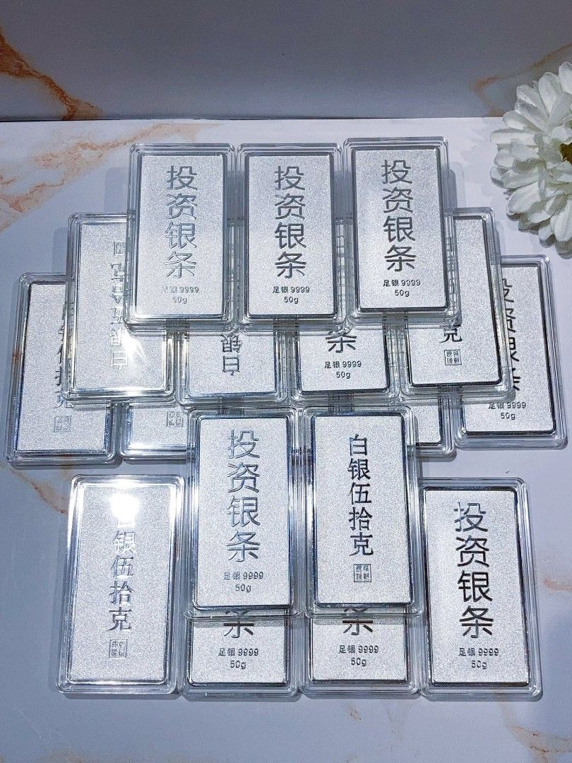 Silver Bars 50g/100g/1000g (Category: Currency) located in Manila. Submitted by primejewelry (Listing ID 1424529413, Image 1). Description: Silver bars available in various weights: 50g, 100g, and 1000g. The bars are marked with Chinese characters and the purity of 999.9. Some bars are in individual protective cases, while others are sealed in plastic. The brand name "Song Da Sheng" is visible on some of the 1000g bars..