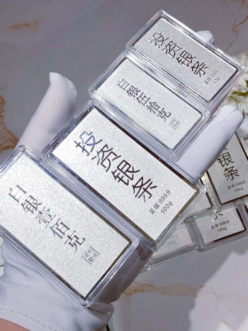 Silver Bars 50g/100g/1000g (Category: Currency) located in Manila. Submitted by primejewelry (Listing ID 1424529413, Image 2). Description: Silver bars available in various weights: 50g, 100g, and 1000g. The bars are marked with Chinese characters and the purity of 999.9. Some bars are in individual protective cases, while others are sealed in plastic. The brand name "Song Da Sheng" is visible on some of the 1000g bars..
