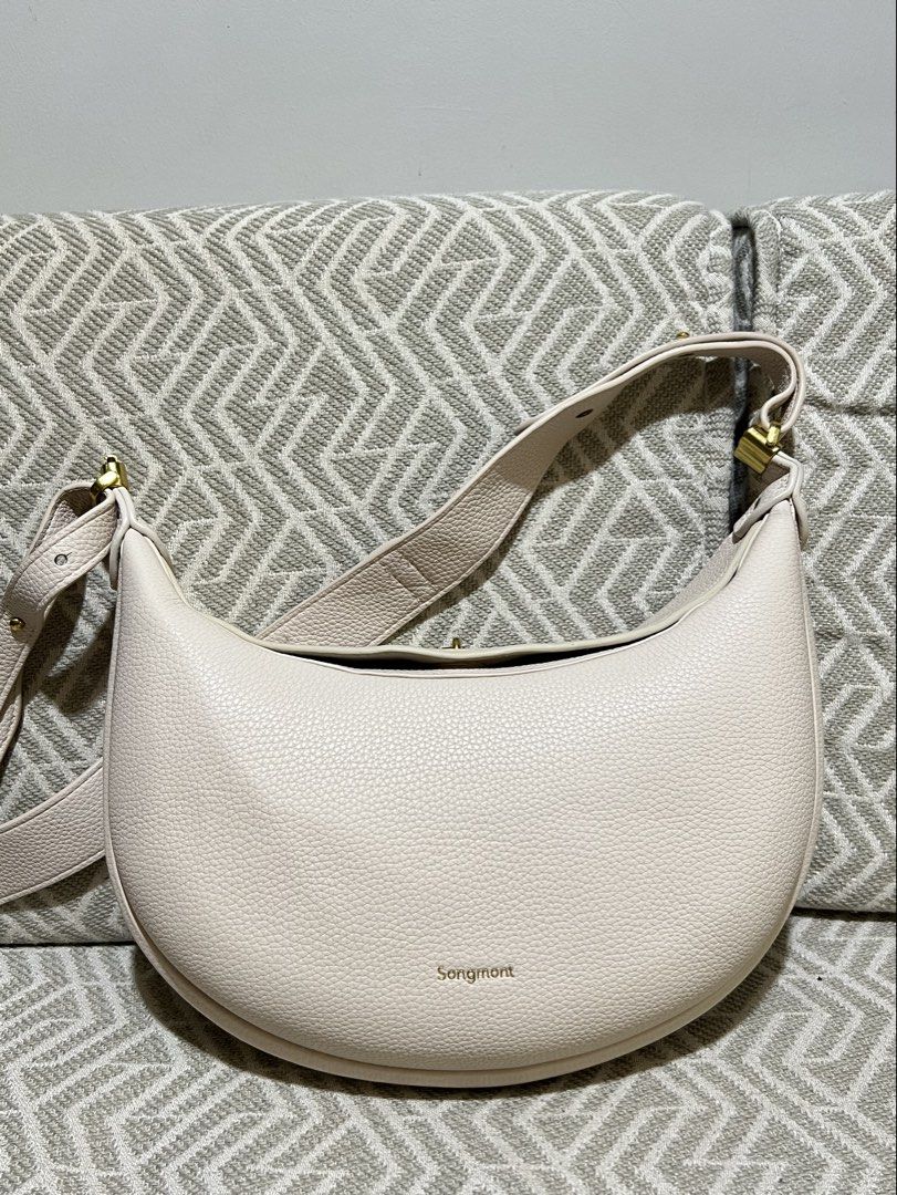 Songmont Luna Ivory (medium) (Category: Luxury Bags & Wallets) located in Cavite. Submitted by marielfradez (Listing ID 1424542322, Image 1). Description: Songmont luna in ivory. Lost handle. Comes with a long strap. Like new..