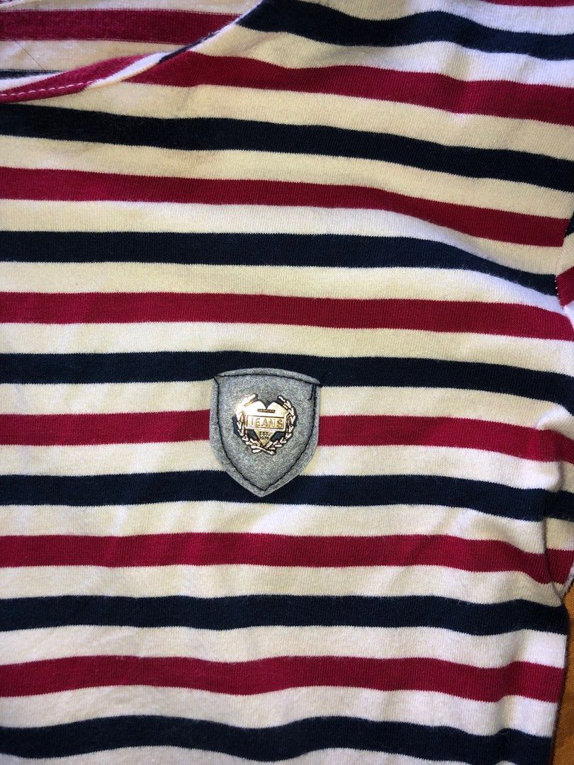 Striped Long Sleeve Shirt (Category: Longsleeves) located in Alcala. Submitted by grisch (Listing ID 1424527511, Image 2). Description: - Striped long sleeve shirt - Brand: Jeans - Size: XS-S - Color: Red, navy, and white stripes - Features a small emblem detail - Versatile and stylish has a super minor issue (check last image).