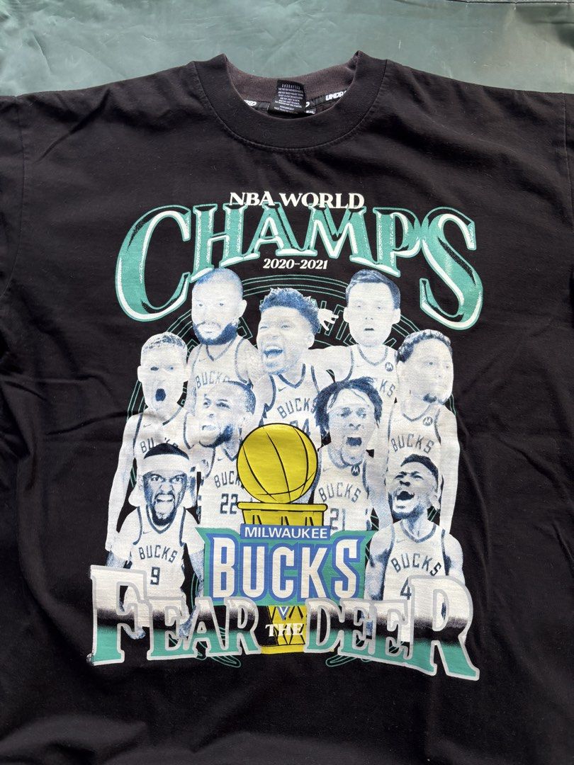 Undrafted NBA World Champs 2021 Bucks Tee (Category: Tshirts & Polo Shirts ) located in Paranaque City. Submitted by fusionquazar (Listing ID 1424611530, Image 1). Description: - Official Undrafted NBA World Champs 2021 Milwaukee Bucks tee. - Features a graphic of the team and the words "FEAR THE DEER". - Player names listed on the back. - Size: 2XL.