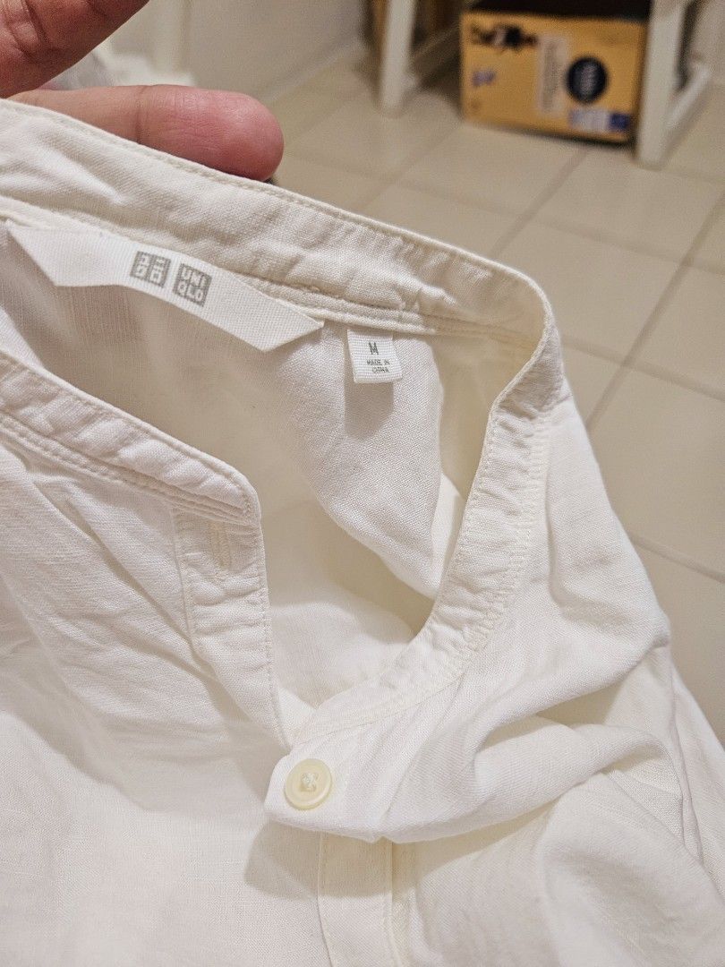 Uniqlo White Shirt - Size M (Category: Shirts) located in Manila. Submitted by teilybam (Listing ID 1424690716, Image 3). Description: White shirt from Uniqlo. It has a mandarin collar and button-down closure. The shirt is size M. The shirt has long sleeves..