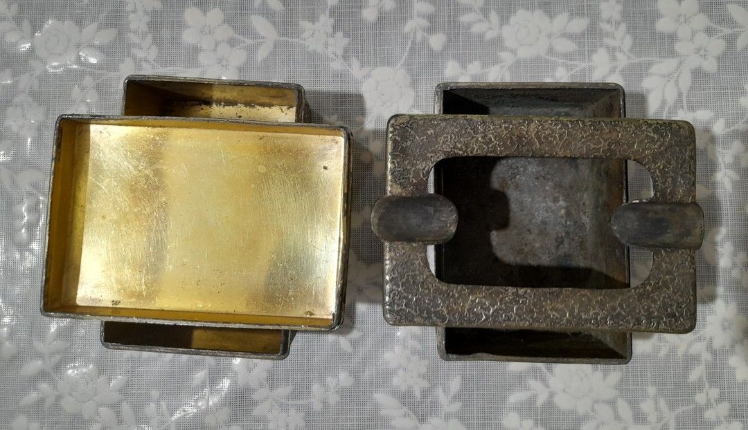 Vintage Metal Ashtray and Cigarette Case Set (Category: Vintage Collectibles) located in Manila. Submitted by miamiga (Listing ID 1424618210, Image 2). Description: - Features a unique textured design - Includes both an ashtray and a cigarette case. - Aged appearance with signs of usage, showing signs of vintage charm. - The cigarette case has a gold interior to prevent the metal from reacting with the cigarette. - Perfect for collectors or those