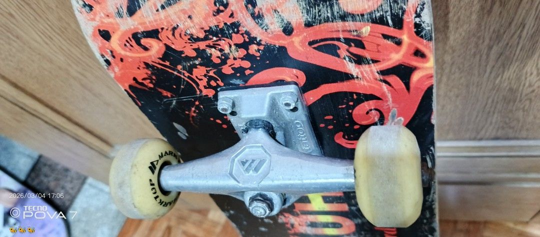 Xiao Chu Skateboard (Category: Skates, Rollerblades & Scooters) located in Manila. Submitted by jhaylex_0422 (Listing ID 1424606440, Image 3). Description: Skateboard features a black deck with red and orange graphics. It has silver trucks and yellow wheels. The deck has some wear and tear. The brand name "Xiao Chu" is visible on the deck. The wheels have "TOP MARK" printed on them..
