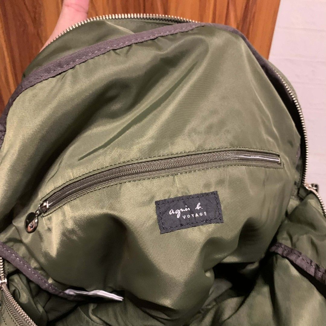 Agnes B. Voyage Green Shoulder Bag (Category: Luxury Bags & Wallets) located in Carmen. Submitted by ar_thrift00 (Listing ID 1424798345, Image 3). Description: Authentic Agnes B. Voyage shoulder bag in green. Features a top handle and a detachable shoulder strap. It has a front zipper pocket and a main compartment with a zipper closure. The interior has a small pocket with a brand tag. The bag has silver-tone hardware and a nylon exterior..