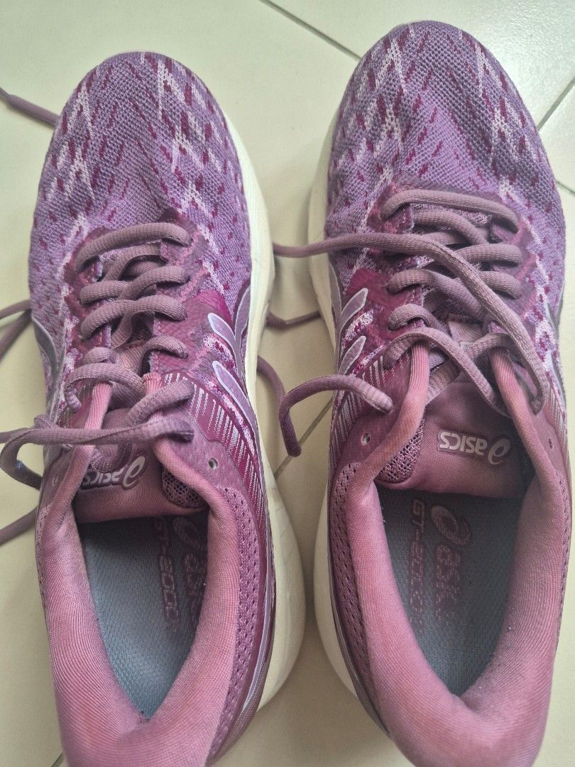 Asics GT-2000 9 Running Shoes (Category: Sneakers) located in Quezon City. Submitted by _jc.u_ (Listing ID 1424741662, Image 1). Description: Asics GT-2000 9 running shoes in purple. Features a breathable upper and a durable rubber sole. The size is US 7.5, EUR 39, and 24.5 cm. The shoes have a lace-up closure. The soles show some signs of wear. Made in Vietnam..