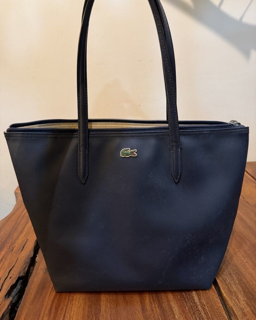 Auth Small Lacoste Concept Bag (Category: Shoulder Bags) located in Iloilo. Submitted by mimipdoo (Listing ID 1424813037, Image 1). Description: Auth Lacoste Small Concept Tote Bag still in good condition well kept inside a display cabinet honest issue: removable dust/dirt around the bag, cracks within the attached strap of the bag, & deform at the back 📍Iloilo City 📦 LBC.