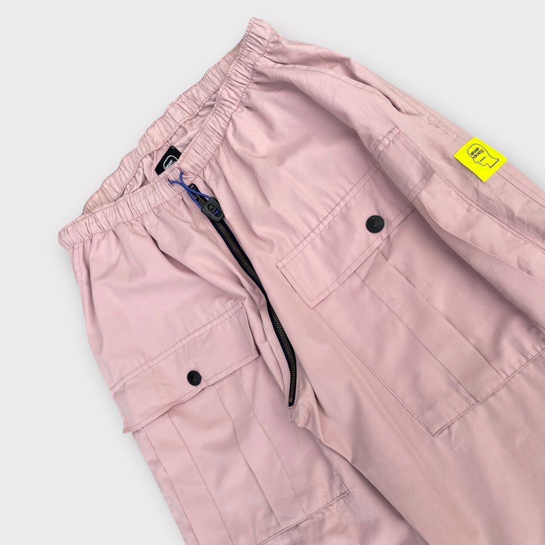 Brain Dead - Nylon Flight Cargo Pants Pink (Category: Activewear) located in Los Banos. Submitted by declutterking (Listing ID 1424867290, Image 3). Description: Size Medium on tag (30-32 waist) Poly blend cargo pants featuring two large front pockets and two hand pockets, elastic drawcord waist, and drawcord hems. Dimensions: 14.75" waist 13.25" front rise 15" thigh 35.5" length 9.25" leg opening Good as new condition Authentic.