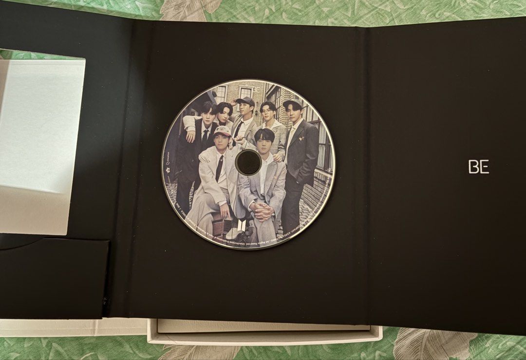 BTS BE Deluxe Edition Album (Category: CDs & DVDs) located in Panabo. Submitted by taecompli (Listing ID 1424792326, Image 3). Description: - Includes photobook, CD, making book, lyric poster, photo frame, 7 postcards, and poster -Section of the photobook became detached - Unsealed.