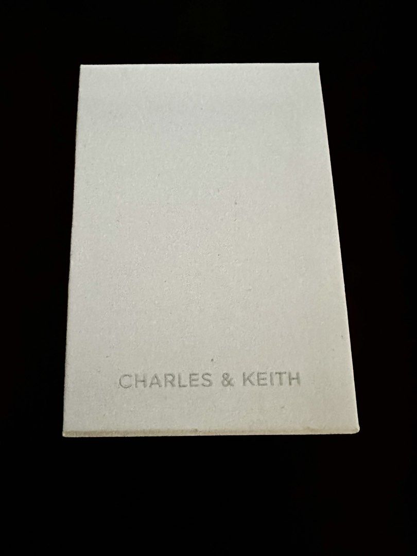 Charles & Keith Silver Necklace (Category: Necklaces) located in Quezon City. Submitted by spatio (Listing ID 1424710002, Image 3). Description: Elegant Charles & Keith necklace. Features a silver chain with a decorative pendant. The pendant has a spherical design with crystal embellishments and two dangling silver charms. Comes with its original box..