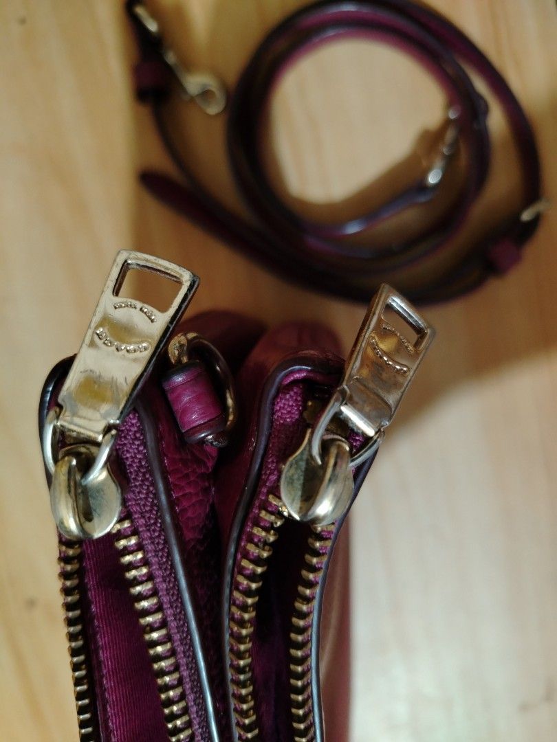 Coach Double Zip Wristlet Crossbody Bag (Category: Luxury Bags & Wallets) located in Tanza. Submitted by maryannrod99102 (Listing ID 1424877840, Image 3). Description: Coach wristlet features a vibrant purple color and a double-zip design. It includes a detachable crossbody strap for versatile carrying options. The interior reveals multiple compartments, including a slip pocket. The zippers and hardware are gold-toned. The Coach logo is visible o