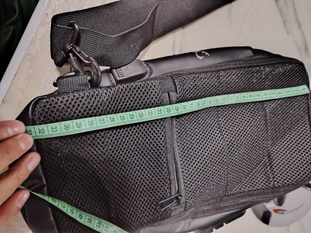 Cross Body Bag for men (Category: Sling Bags) located in Manila. Submitted by drxx.drip_19 (Listing ID 1424818477, Image 3). Description: - Preloved cross body bag for men. - Classic black color. - Features a USB charging port. - Stylish and practical design..