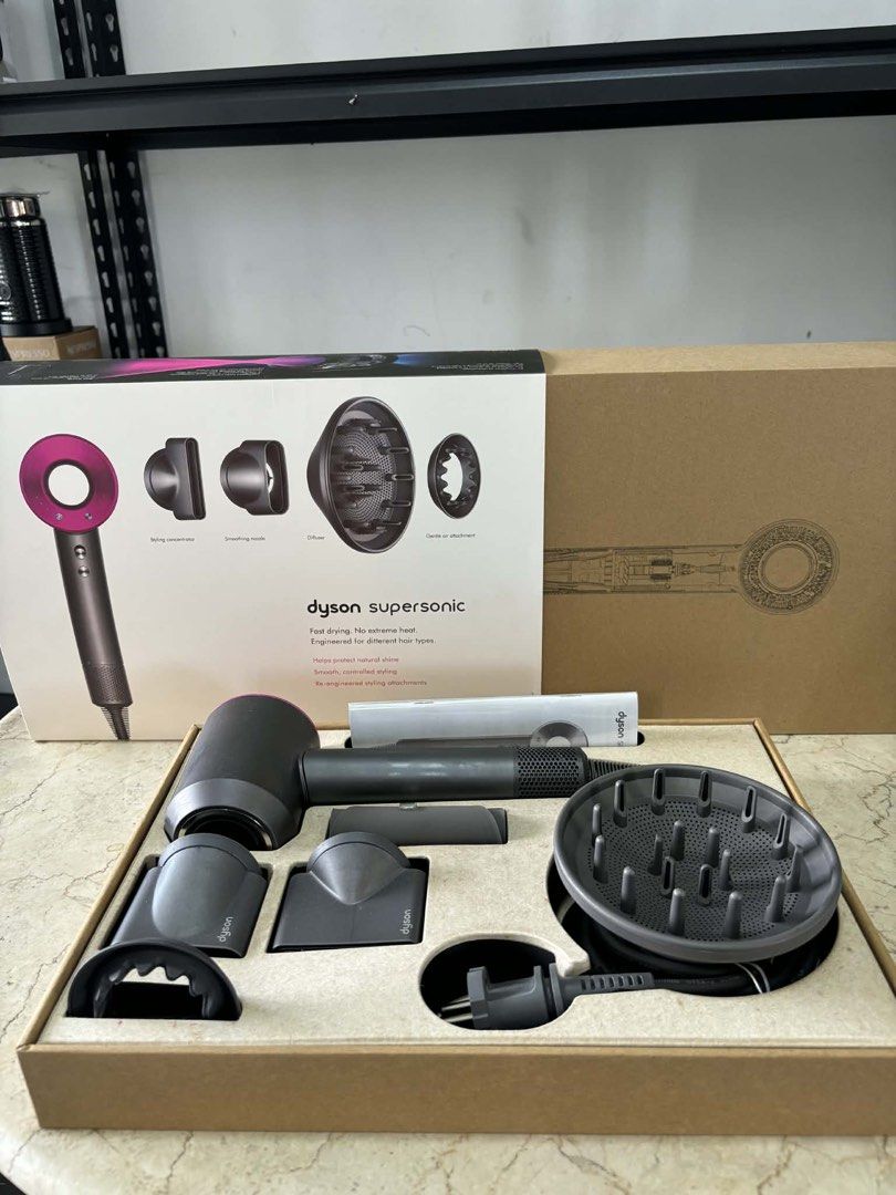 Dyson Supersonic Hair Dryer (Category: Hair) located in Bulacan. Submitted by islafinds.ph (Listing ID 1424826687, Image 2). Description: - Dyson Supersonic hair dryer - Includes: Diffuser, styling concentrator, smoothing nozzle - Comes with original box and power cord - Color: Dark grey and pink.