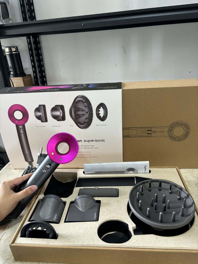 Dyson Supersonic Hair Dryer (Category: Hair) located in Bulacan. Submitted by islafinds.ph (Listing ID 1424826687, Image 1). Description: - Dyson Supersonic hair dryer - Includes: Diffuser, styling concentrator, smoothing nozzle - Comes with original box and power cord - Color: Dark grey and pink.