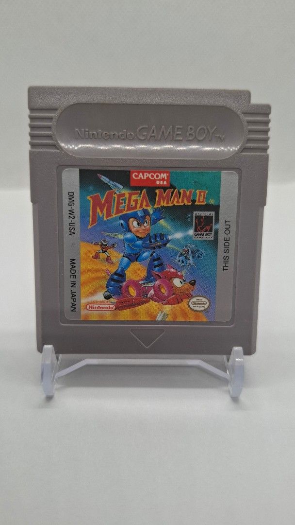 Gameboy Mega-Man 2 with cartridge case protector (Category: Nintendo) located in San Juan City. Submitted by ricsgaragesale (Listing ID 1424776857, Image 2). Description: Mega-Man 2 Gameboy. Price: 2,500 PHP - Authentic. - Tested and working. - Pristine label condition and the cartridge case is in good condition, kindly check the pictures. - With 1 free authentic cartridge case protector. Issue: There's a slightly yellowish at the back of the car