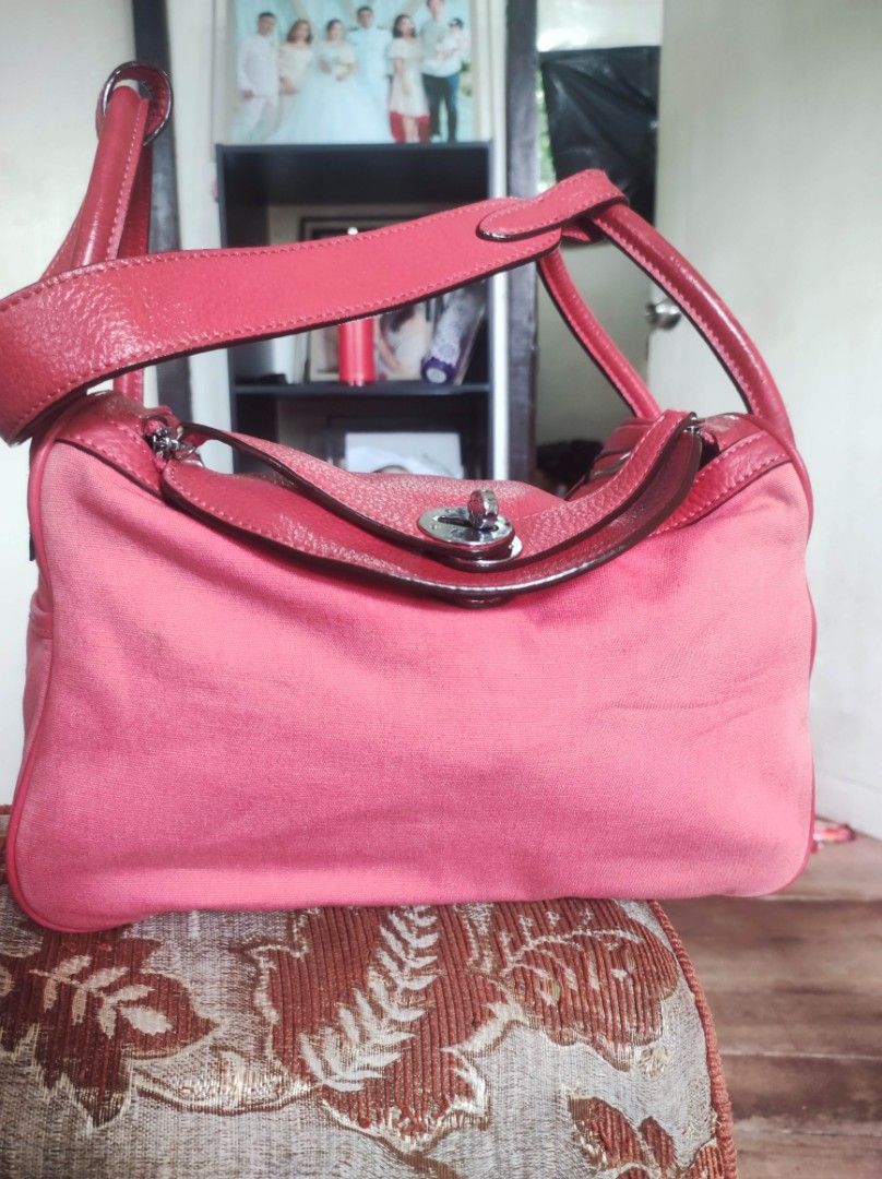 Hermes Pink Handbag (Category: Luxury Bags & Wallets) located in Zamboanga. Submitted by Clairey03 (Listing ID 1424749540, Image 1). Description: Pink handbag with leather handles and trim. Features a silver-tone clasp with the Hermes logo. Includes a shoulder strap. The bag has a rectangular shape with a spacious interior..