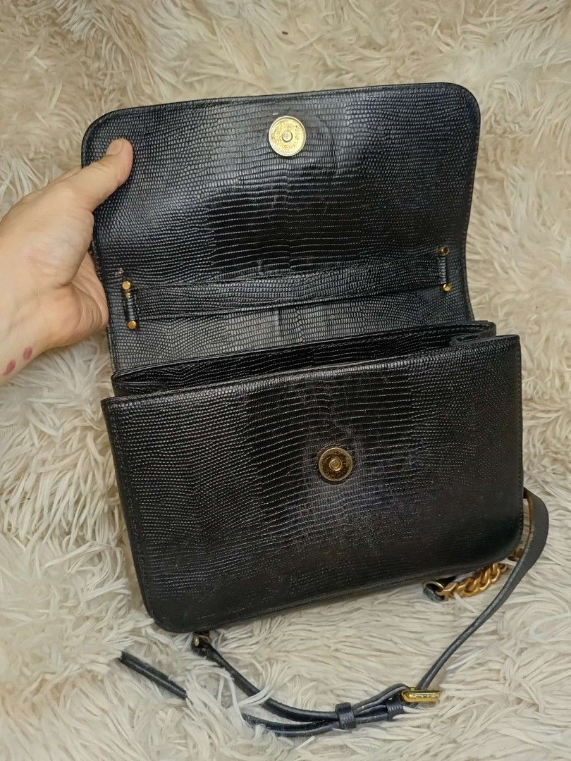 Jill Stuart Black Shoulder Bag with Gold Chain (Category: Shoulder Bags) located in Manila. Submitted by mariecunan80818 (Listing ID 1424708748, Image 3). Description: Black shoulder bag by Jill Stuart. Features a gold chain strap and a flap closure with a decorative charm. The interior includes multiple compartments, including a zippered pocket. The bag has a textured finish and a gold buckle on the adjustable strap. The interior is lined with b
