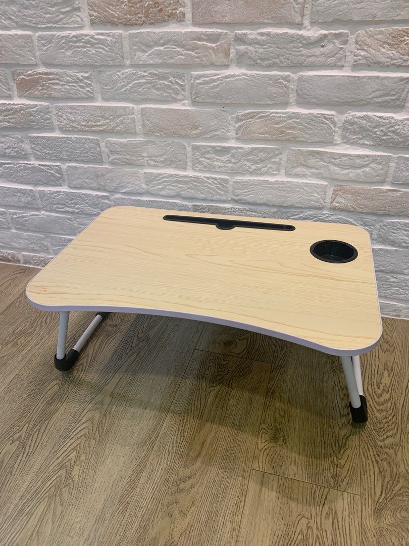 Laptop foldable table bed work desk small (Category: Tables & Sets) located in Singapore. Submitted by debe_closet (Listing ID 1424817841, Image 1). Description: Foldable laptop table Light brown Cup holder and tablet holder 60cm x 40cm Height is 25cm.