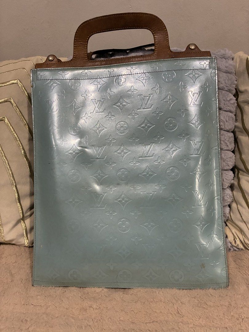 Louis Vuitton Monogram Vernis Stanton Tote bag (Category: Luxury Bags & Wallets) located in Manila. Submitted by cellymeji060371 (Listing ID 1424738906, Image 2). Description: Authentic Louis Vuitton Vernis tote bag in a light blue color. Features a brown leather handle and gold-tone hardware. The bag has the signature LV monogram pattern embossed on the exterior. Includes a lock and key. Made in France. Flaws: Date code not visible anymore maybe