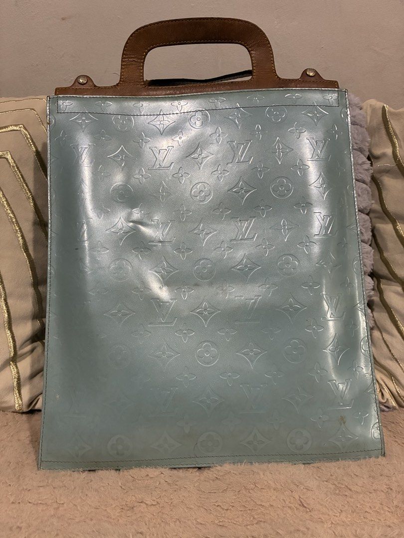 Louis Vuitton Monogram Vernis Stanton Tote bag (Category: Luxury Bags & Wallets) located in Manila. Submitted by cellymeji060371 (Listing ID 1424738906, Image 3). Description: Authentic Louis Vuitton Vernis tote bag in a light blue color. Features a brown leather handle and gold-tone hardware. The bag has the signature LV monogram pattern embossed on the exterior. Includes a lock and key. Made in France. Flaws: Date code not visible anymore maybe