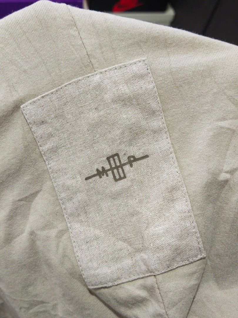 Madness Pocket Tee (Category: Tshirts & Polo Shirts ) located in Manila. Submitted by djs777 (Listing ID 1424792439, Image 3). Description: - Madness pocket tee in beige - Features a unique graphic on the chest pocket - Made from 100% cotton - Relaxed fit - Includes care label with washing instructions.