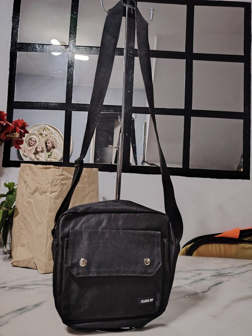 Mens sling bag black (Category: Sling Bags) located in Manila. Submitted by drxx.drip_19 (Listing ID 1424818480, Image 1). Description: - Black men's sling bag - Stylish and simple design - Features a front pocket - Adjustable strap for comfort - Ideal for everyday use.