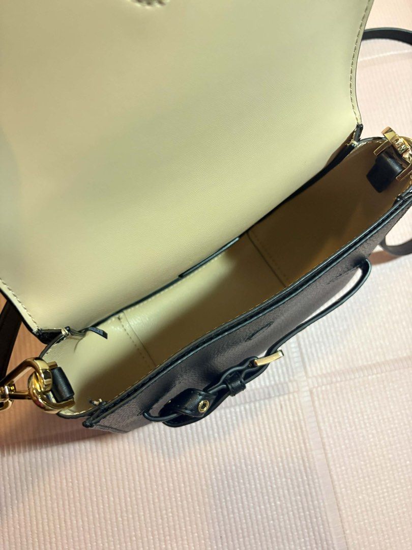Michael Kors Black Crossbody Bag (Category: Luxury Bags & Wallets) located in Bacolod City. Submitted by reneelim_ (Listing ID 1424784704, Image 3). Description: Michael Kors Emilia Small Saddle Crossbody Bag Condition: Like brand new ✔️ 100% authentic ✔️ Crafted from premium pebbled leather or signature logo-print canvas ✔️ Adjustable crossbody strap (approx. 18.5”–22.5” drop) ✔️ Magnetic flap closure with stylish belt/buckle detail ✔️ Compact s