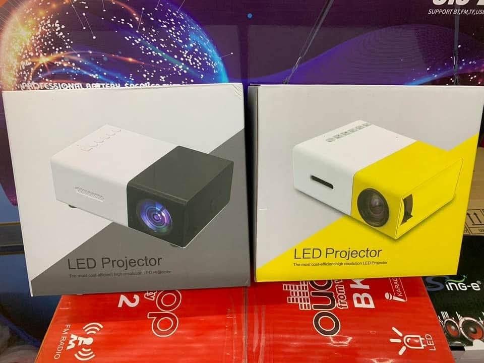 Mini LED Projector - Portable Home Theater (Category: Projectors) located in Mandaluyong City. Submitted by shopmla (Listing ID 1424819972, Image 1). Description: Mini Projector Php 880. Portable LED Mini Projector Mini Home Theater HDMI Mini Projector HD 1080P Compact and portable LED projector for home entertainment. Supports 1080P resolution with 600 lumens brightness and a 80" display. Features multiple input options including HDMI, USB, and 