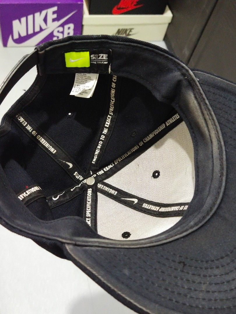 Nike Cap (Category: Caps & Hats) located in Manila. Submitted by djs777 (Listing ID 1424791806, Image 2). Description: Black Nike cap with a white Nike logo on the front. The cap has a flat brim and a structured crown. The interior features Nike branding and size information. It has a classic, sporty design..
